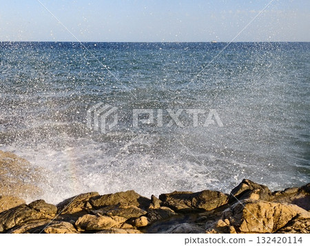 quiet coast with misty waves, peaceful seaside scene with mist and softly retreating surf waves 132420114