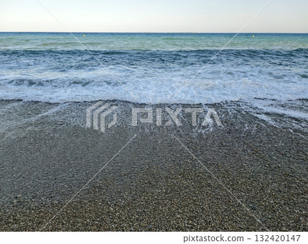 calm horizon over rocky shore with soft waves enhances peaceful atmosphere for meditation and yoga calm horizon over rocky shore with soft waves enhances peaceful atmosphere for meditation and yoga 132420147