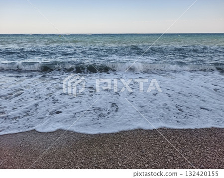 gentle waves kiss quiet pebble beach, peaceful horizon with soft surf and tranquil sea ambiance gentle waves kiss quiet pebble beach, peaceful horizon with soft surf and tranquil sea ambiance 132420155
