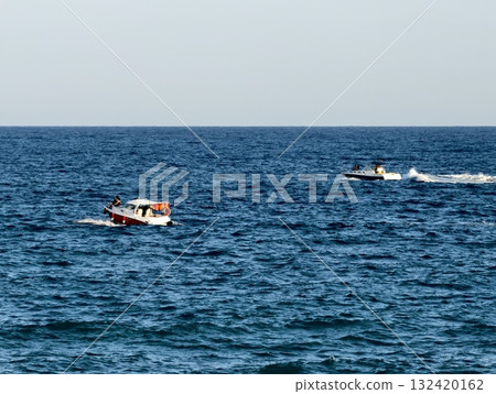 rescue vessel chases jet ski over waves, rescue boats pursue jet skis amid choppy waters and spray 132420162