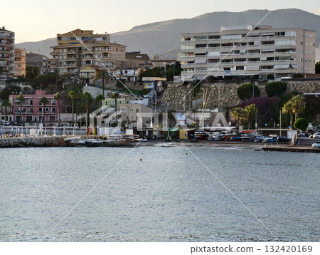 harborfront village with boats and cafes, quaint waterfront with colorful boats and lively market 132420169