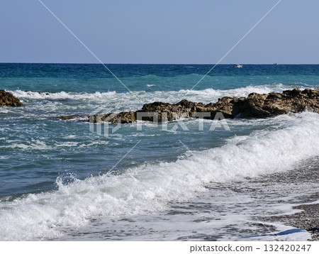 sunny ocean scenery, bright day with ocean waves, gentle tide with blue surf breaking on rocks sunny ocean scenery, bright day with ocean waves, gentle tide with blue surf breaking on rocks 132420247