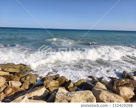 furious waves crashing against rocks, raging ocean waves impacting jagged coastal barriers vividly furious waves crashing against rocks, raging ocean waves impacting jagged coastal barriers vividly 132420266