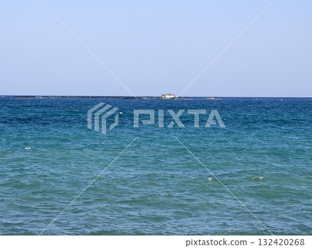 serene ocean view, serene turquoise expanse featuring distant boat on calm waters beneath clear sky 132420268