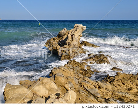 constant ocean waves sculpt and define limestone formations illuminated by midday ochre highlights constant ocean waves sculpt and define limestone formations illuminated by midday ochre highlights 132420271