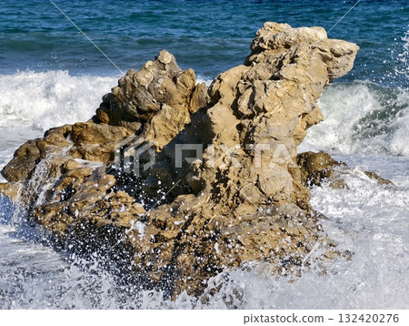 frosted ocean spray over rocks, ocean spray frozen on rocks with sparkling highlights and texture 132420276