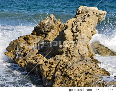 eroded stone formations meet turbulent sea, dynamic wave action sculpts jagged coastal rocks vividly eroded stone formations meet turbulent sea, dynamic wave action sculpts jagged coastal rocks vividly 132420277