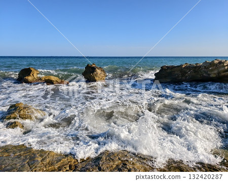 wave spray eruption, energetic wave eruption near coastal rocks with vibrant spray and textured 132420287