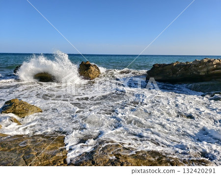 explosion meets rocky terrain energetically, powerful wave impacts jagged rocks with force explosion meets rocky terrain energetically, powerful wave impacts jagged rocks with force 132420291