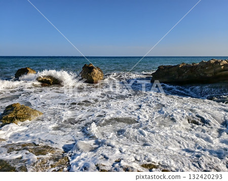 waves reveal rocks, waves continually reveal previously concealed rocks beneath surface of water 132420293