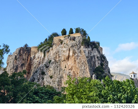 breathtaking natural fortress with weathered textures and vibrant silhouette under bright sky 132420326
