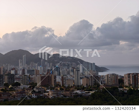 coastal sunset scene, golden sunset over calm bay, dramatic clouds over tranquil coastal city coastal sunset scene, golden sunset over calm bay, dramatic clouds over tranquil coastal city 132420334
