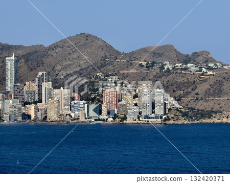 lively coastal urban area, energetic beachfront cityscape filled with hotels and leisure activities 132420371