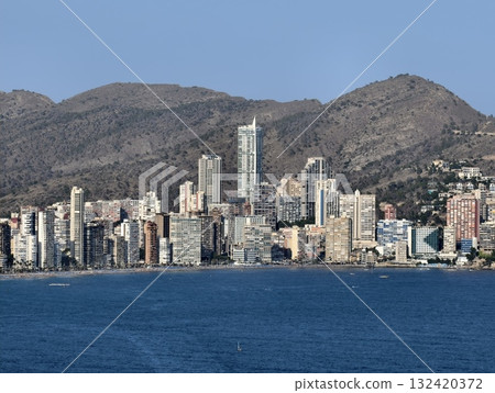 bright coastal area with lively vibe, vibrant daytime waterfront with highrise buildings and active 132420372