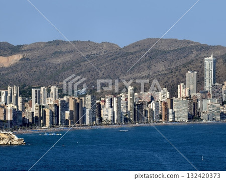 bright daylight illuminates bustling shoreline filled with clustered skyscrapers over deep blue bright daylight illuminates bustling shoreline filled with clustered skyscrapers over deep blue 132420373
