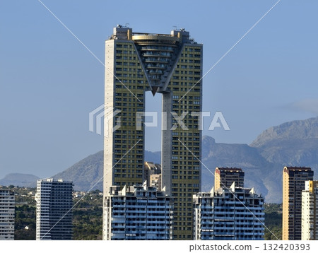 architectural structure with exposed columns, symmetrical arch connecting towers with concrete 132420393