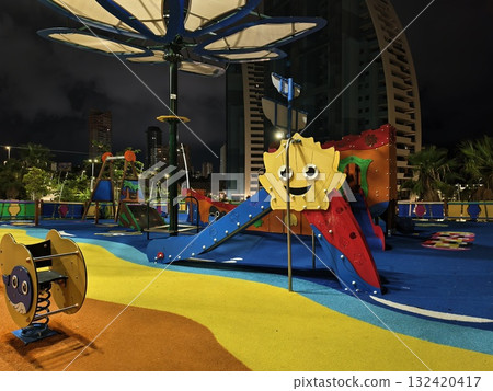 vibrant playground scene, urban playground with cheerful sun sculpture and tranquil evening ambiance vibrant playground scene, urban playground with cheerful sun sculpture and tranquil evening ambiance 132420417