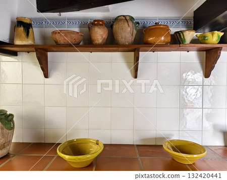 rustic kitchen setup with handmade ceramics, cozy cottagecore kitchen with terracotta and glazed 132420441