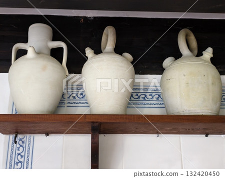 curatorstyled showcase featuring three amphora vessels with muted glaze finish and harmonious layout curatorstyled showcase featuring three amphora vessels with muted glaze finish and harmonious layout 132420450