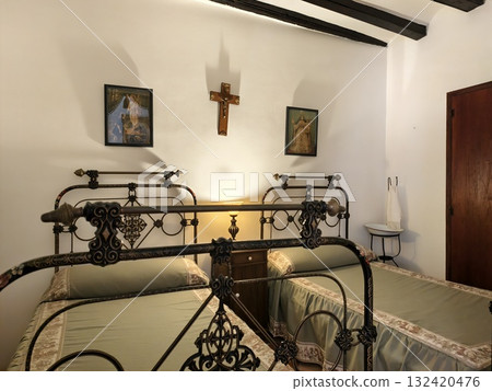 peaceful religious inn bedroom with vintage touches, quiet inn room with religious decor and rustic 132420476