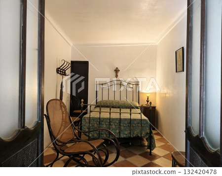 charming bedroom with vintage decor, vintage bedroom featuring wrought iron bed and artwork 132420478