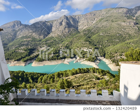 terrace overlooking mountainous reservoir, terrace offering views of turquoise water and rugged 132420489