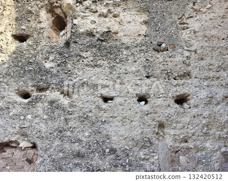 eroded stone surface, weathered wall with niches, closeup of aged stone showing erosion and cavities eroded stone surface, weathered wall with niches, closeup of aged stone showing erosion and cavities 132420512