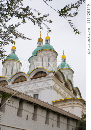 View of the domes of the Assumption Cathedral of the Astrakhan Kremlin on a cloudy autumn day. View of the domes of the Assumption Cathedral of the Astrakhan Kremlin on a cloudy autumn day. 132420549