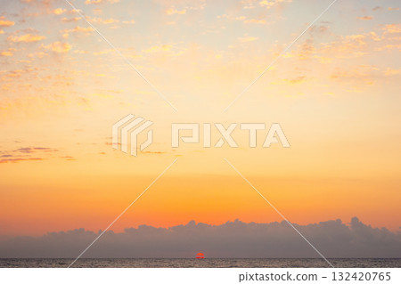 blue sky with orange clouds. nature background at sunrise. sun on the horizon of sea blue sky with orange clouds. nature background at sunrise. sun on the horizon of sea 132420765