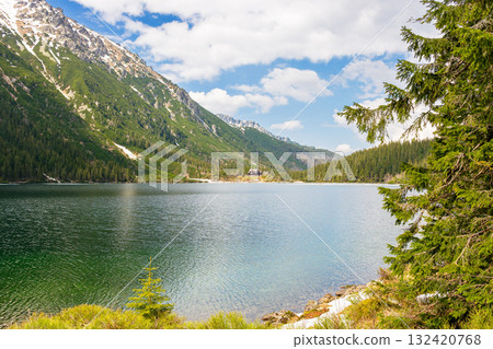 landscape with alpine lake in spring. beautiful view near rysy rocks in snow. travel background with sky and clouds 132420768