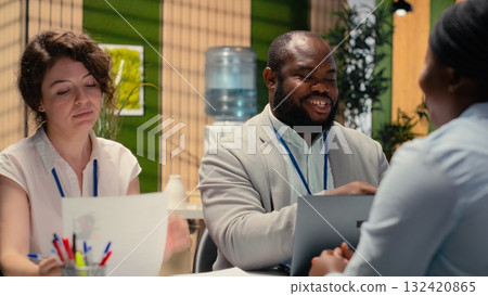 Diverse HR interviewers meeting with an applicant to review CV document, focusing on talent acquisition, work experience and qualifications for onboarding process in enterprise. 132420865