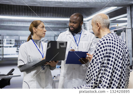 Diverse scientists performing observation and examination of a patient in a research lab, testing a new treatment and analyzing dosage effects. Studying risks and outcomes for progress. 132420895