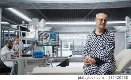 Portrait of old person waiting for drug testing in modern laboratory, wearing hospital robe and preparing for a clinical trial to obtain new treatment. Breakthrough in biomedicine. Camera A. Portrait of old person waiting for drug testing in modern laboratory, wearing hospital robe and preparing for a clinical trial to obtain new treatment. Breakthrough in biomedicine. Camera A. 132420988