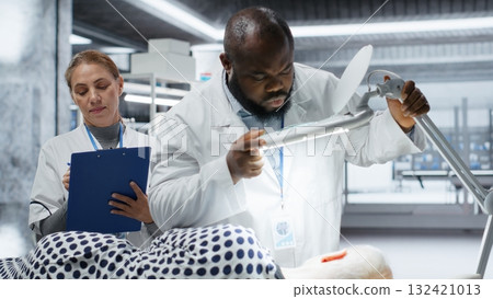 Professionals use magnifying glass to perform examination in a drug trial with patient, monitoring vitals and analyzing reactions. Studying dosage safety for biomedicine and toxicology. Camera B. Professionals use magnifying glass to perform examination in a drug trial with patient, monitoring vitals and analyzing reactions. Studying dosage safety for biomedicine and toxicology. Camera B. 132421013