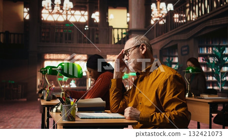 Aged performer engaged in dramaturgy and script practice with lines, demonstrating creativity and discipline during drama rehearsal. Passion for storytelling and reenactment. 132421073