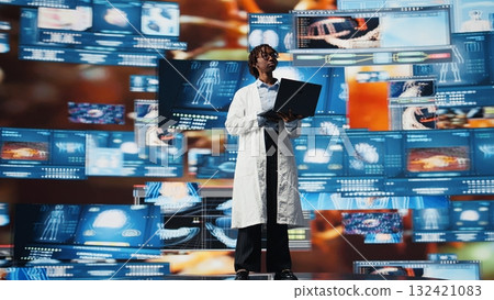 Female scientist looking at genomes on laptop screen, comparing infection models. African american biomedical engineer studying pathogens using notebook to design antiviral strategies, camera A 132421083
