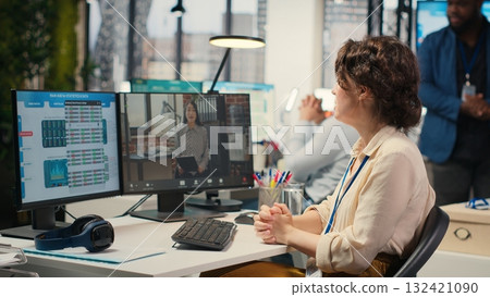 Businesswoman participates at web chat event with a shareholder, sharing insight on performance metrics for a briefing. Video conferencing in the office between business associates. Camera B. Businesswoman participates at web chat event with a shareholder, sharing insight on performance metrics for a briefing. Video conferencing in the office between business associates. Camera B. 132421090