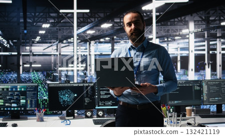 Data center manager presents AI technology to shareholders, demonstrating predictive maintenance capabilities. Man briefing investors on server hub artificial intelligence infrastructure, camera A Data center manager presents AI technology to shareholders, demonstrating predictive maintenance capabilities. Man briefing investors on server hub artificial intelligence infrastructure, camera A 132421119