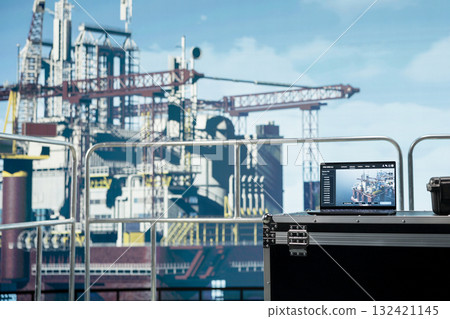 Laptop on offshore platform with software used to monitor equipment components performance in real time. Notebook on drilling rig deck used to calibrate infrastructure with asset management system Laptop on offshore platform with software used to monitor equipment components performance in real time. Notebook on drilling rig deck used to calibrate infrastructure with asset management system 132421145