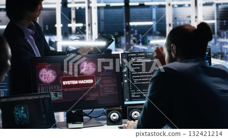 Engineers in AI server hub alerted by hacking incident involving theft of sensitive data. Teamworking data center employees alarmed by computer virus triggered by security systems, camera A 132421214