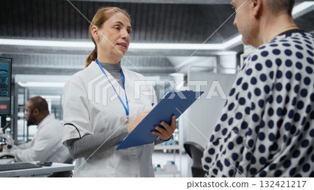 Medic performing detailed examination of a patient to test a new treatment, writing down the side effects. Clinical research with toxicology analysis to monitor dosage response. Camera A. Medic performing detailed examination of a patient to test a new treatment, writing down the side effects. Clinical research with toxicology analysis to monitor dosage response. Camera A. 132421217