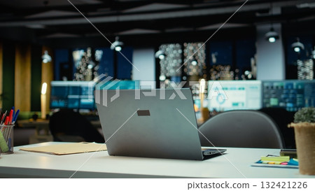 Modern empty office glows with the light of performance metrics and forecasting graphs. Corporate space equipped with technology and computers reflects administration of enterprise objectives. Modern empty office glows with the light of performance metrics and forecasting graphs. Corporate space equipped with technology and computers reflects administration of enterprise objectives. 132421226