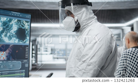 Scientist in hazmat suit checking DNA molecules of infected patient in a bioscience lab, analyzing pathology and virology data, testing immunology theories and developing vaccines. Camera B. Scientist in hazmat suit checking DNA molecules of infected patient in a bioscience lab, analyzing pathology and virology data, testing immunology theories and developing vaccines. Camera B. 132421268