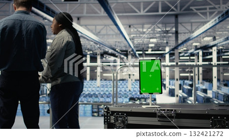 Green screen tablet in server room in front of admins optimizing deep learning systems handling tasks. Mockup device used by data center workers adjusting AI model parameters, camera A 132421272