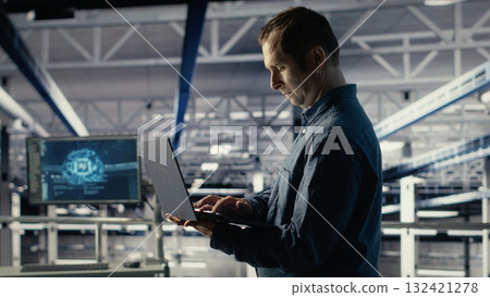 Data center admin on industrial platform checks AI dashboard using laptop. Man in server farm tests artificial intelligence tools on notebook to ensure reliable performance, camera B Data center admin on industrial platform checks AI dashboard using laptop. Man in server farm tests artificial intelligence tools on notebook to ensure reliable performance, camera B 132421278