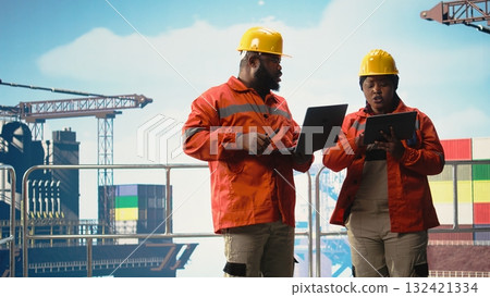 Drilling rig technicians tracking oil production efficiency, coordinating checkup operations. Offshore installation manager and worker use devices to evaluate system performance, Drilling rig technicians tracking oil production efficiency, coordinating checkup operations. Offshore installation manager and worker use devices to evaluate system performance, 132421334