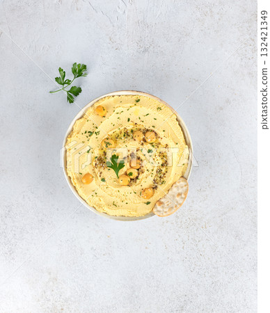 Lupin hummus or turmeric hummus with olive oil and herbs on a white background. Healthy vegan concept. 132421349