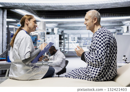 Healthcare specialist examining old patient during a drug trial in laboratory, monitoring treatment outcomes, side effects and dosage response. Advancing biomedicine and health innovation. Healthcare specialist examining old patient during a drug trial in laboratory, monitoring treatment outcomes, side effects and dosage response. Advancing biomedicine and health innovation. 132421403
