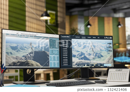 Advanced wind turbine models displayed on multi monitor PC setup in empty office. Innovative VAWT turbine in CAD software on computer display in alternative technology company workplace Advanced wind turbine models displayed on multi monitor PC setup in empty office. Innovative VAWT turbine in CAD software on computer display in alternative technology company workplace 132421406