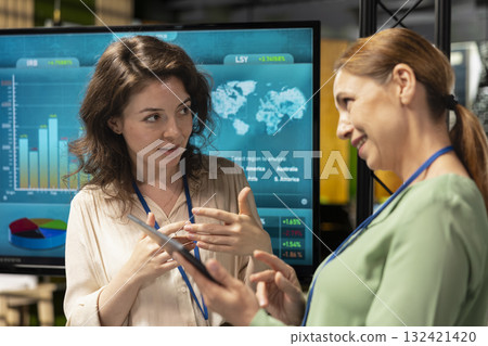 Professional group of female associates analyzing project documents fueled by collaboration and determination, aligning corporate goals to build a unified vision. Networking concept. Professional group of female associates analyzing project documents fueled by collaboration and determination, aligning corporate goals to build a unified vision. Networking concept. 132421420